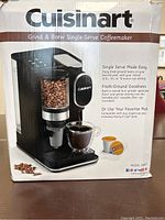 Photo of the Cuisinart Grind & Brew Single-Serve Coffeemaker in its retail packaging showing product image and features