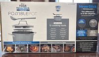 Photo of unopened boxed Ninja Foodi NeverStick Possible Pot Premium Set showing front panel with details on included items, technology, and use cases.