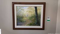 Framed oil painting landscape of wooded scene with signature by Gisela visible