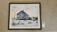 Full view of the framed watercolor painting showing an old barn in snow during sunset or sunrise, with soft pastel sky colors.