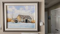 Full view of the original framed painting of a barn in winter landscape.