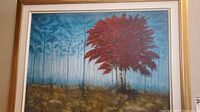 Full view of the painting showing the red tree in front and misty blue background framed in a golden frame with white and cream matting.