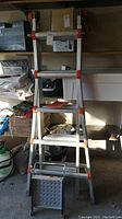 Full front view of ladder extended in A-frame position within garage.
