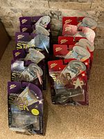 All eleven unopened Johnny Lightning Legends of Star Trek starship figurines arranged on carpet floor.