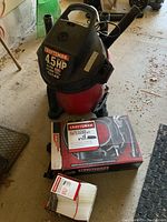 Full view of the Craftsman vacuum and included accessories - car cleaning kit, spare filter, wheeled dolly
