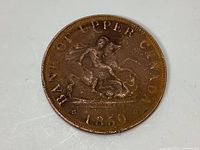Obverse side of the 1850 Bank of Upper Canada half penny token showing the seated figure and date 1850.