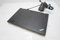 Closed Lenovo ThinkPad L430 laptop showing black lid with Lenovo and ThinkPad logos.