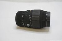 Side view of Sigma 70-300mm f/4-5.6 DG Macro telephoto zoom lens showing zoom and focus rings, lens markings and mount.