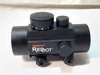 Front side view of Tasco Red Dot Sight showing adjustment turrets and mounting screws.