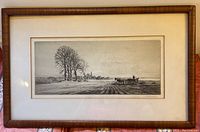 Framed black and white lithograph of a country landscape with trees, horse-drawn cart, and village in background.