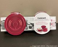 Set of 2 red Cuisinart mini round covered cocottes in original packaging, front view.