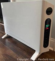 White digital convection panel heater showing side view, digital display with controls, standing on wooden floor.
