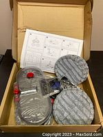 Mop head with two microfiber mop pads and instruction sheet inside cardboard box, sealed in plastic.