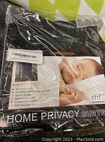 New packaged curtain panel showing label and key features including light blocking, insulation, energy saving, noise reduction, privacy, and soft fabric.