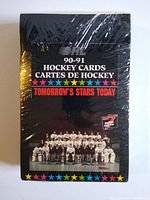 Front of sealed black wax box packaging showing 1990-91 OHL hockey card set. Team photo and colorful star border visible.