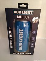 Front view of the sealed Bud Light Tall Boy Bluetooth Speaker in packaging showing branding and product features including Bluetooth and 6 hour battery life.