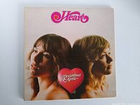 Front cover of Heart's Dreamboat Annie LP showing two women facing opposite directions with the album title in a pink heart between them.