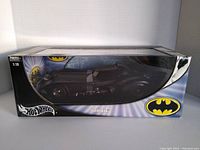 Front view of the Hot Wheels Elite Batmobile 1:18 scale model in original box with clear display window and Batman branding.