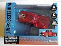 Front of box showing hot rod pickup truck speaker with Bluetooth, LED lighting, FM radio, and MP3 player features