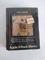 Front side of sealed John Lennon Walls & Bridges Apple 8-Track Stereo tape showing album artwork, Apple logo, and retail sticker.