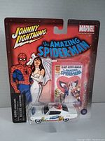 Front view of factory sealed Johnny Lightning Amazing Spider-Man 1970 AMC Rebel Machine diecast car in packaging