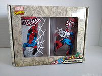 Front view of the Marvel Comics Spider-Man glassware set box showing two glasses with Spider-Man graphic designs inside.