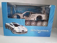 Front view of the Spy Hunter 2 Saleen S-7 model in original sealed box showing the silver diecast car and blue packaging with branding.