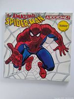 Front cover of The Amazing Spider-Man Rockomic LP featuring Spider-Man on a spiderweb background with title and special edition sticker.