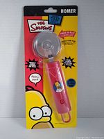 Photo of the front side of factory sealed The Simpsons Homer talking pizza cutter in blister packaging