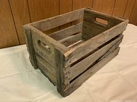 Photo of wooden crate angled to show side with stenciled text 'Canadian Apples'