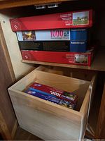 Photo of 6 stacked puzzle boxes, showing brands and some piece counts