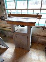 Front angled view showing wood top, fence and cabinet base