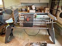 Full side view of Shopsmith Mark V unit on legs, showing headstock, bed rails and legs