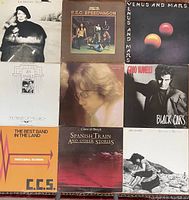 Top view of nine assorted vinyl album covers showing various 1970s artists and bands.