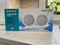 Box front showing Sony XS-MP1610W marine speakers, 6.5 inch, 140 watts, white