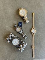 Four ladies watches displayed; two Anne Klein watches, one Liz Claiborne watch, and one unbranded watch with a beaded bracelet.