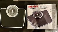 Photo shows the Starfrit Balance Large Screen mechanical scale beside its original box.
