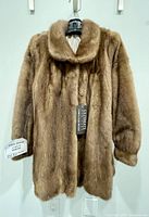 Front view of a women's large mink fur stroller coat in demi buff color, showing collar, sleeves, and fur texture.