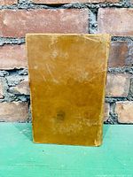 Front cover of the leather bound book showing brown cover with scuff marks