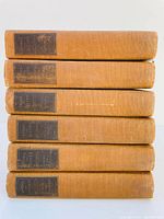 Stacked side view of six volumes in brown cloth covers