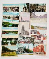 Top-down shot of all 18 St. Catharines Ontario themed postcards arranged on flat surface