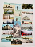 Top view of assortment of 20 antique postcards depicting Toronto landmarks, buildings, waterfronts, and parks.