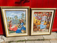 Both framed needlepoint artworks side by side showing full view of embroidery and frame details.