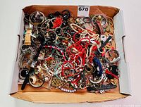 Box containing a large variety of vintage estate jewelry items in very good condition including watches, beaded, and metal bands, necklaces, bracelets, and earrings.