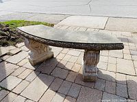 Front view of curved bench top and both scroll-motif supports