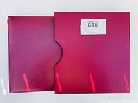 Red binder folder containing the stamp collection