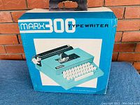Original box of Marx 300 typewriter, blue with image of typewriter and branding