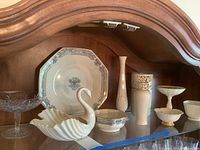 Photo showing all 10 Lenox pieces arranged on a wooden shelf including swan dish, plate, vases, and pedestal compotes