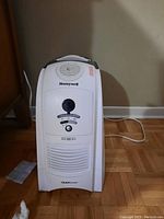 Front view of the white Honeywell QuickSteam humidifier showing the control panel and air vent.