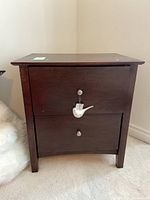 Front view of wood nightstand with two drawers and metal pulls